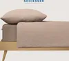 A close-up view of a bed with a pillow and fitted sheet, showcasing the texture and color of the bedding. Produktbild-Vorschau