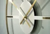 Close-up of a modern wall clock with gold hands and silver accents. Náhled obrázku produktu