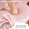 A hand pressing into a soft pink cushion, with text overlays highlighting comfort and fabric. Produktbild-Vorschau