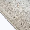 A close-up view of a beige rug with a vintage pattern. Produktbild-Vorschau