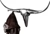 A silver bull head coat rack with a brown leather jacket hanging from it. Produktbild-Vorschau