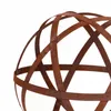 A close-up of a rusty metal garden sphere. Voir les images du produit