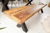 A wooden bench with black X-shaped legs is shown in a room with a white floor. Produktbild-Vorschau