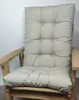 A close-up shot of a beige cushion on a wooden chair. Produktbild-Vorschau