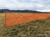 An orange safety net fence is set up in a field with hills in the background. Náhľad obrázku produktu