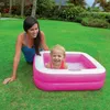 A woman and a child are playing in an inflatable pool in a backyard. Produktbild-Vorschau