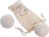 Three wool dryer balls and a drawstring bag are shown against a white background. Produktbild-Vorschau