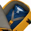 Close-up view of a blue shirt packed inside a yellow backpack. Produktbild-Vorschau
