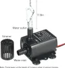 A black submersible water pump with water spraying from the outlet, with labels indicating its parts and dimensions. Podgląd zdjęcia produktu