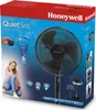 The image shows the packaging of a Honeywell QuietSet oscillating stand fan. The packaging features a picture of the fan, a woman sitting on the floor with a cup, and various icons and text highlighting the product's features. Produktbild-Vorschau