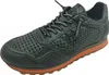 A single green sneaker with an orange sole is shown against a white background. Voir les images du produit
