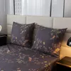 A close-up view of a bed with pillows and bedding featuring a floral pattern. Anteprima dell’immagine prodotto