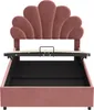 A pink upholstered bed frame with a shell-shaped headboard, shown with the mattress support lifted to reveal storage space underneath. Podgląd zdjęcia produktu