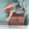 A person sitting on a multi-tiered shelf unit. Podgląd zdjęcia produktu