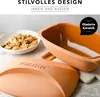 A close-up shot of a terracotta casserole dish and a bowl of food. Produktbild-Vorschau