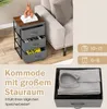 A nightstand with fabric drawers next to a sofa, with a box of folded clothes in the foreground. Podgląd zdjęcia produktu