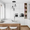 A modern kitchen with white cabinets, a marble countertop island, and a set of pendant lights. Náhled obrázku produktu