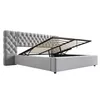 A grey upholstered bed frame with the mattress support mechanism lifted, revealing storage space underneath. Náhled obrázku produktu