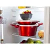 Kitchenware stacked on refrigerator shelves. Anteprima dell’immagine prodotto