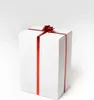 A white gift box with red ribbon and bow on a white background. Produktbild-Vorschau