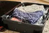 An open suitcase filled with vacuum-sealed clothing. Náhled obrázku produktu