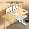A desk with dual monitors, keyboard, mouse, and a phone charging on it, with a drawer extended showing office supplies. Produktbild-Vorschau