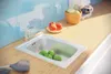 A kitchen sink with apples and limes on a wooden countertop. Náhled obrázku produktu