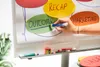 A hand is writing on a whiteboard with colorful circles representing business concepts. Voir les images du produit