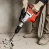 A person using a KRAFT&DELE combi hammer to break up concrete. Náhled obrázku produktu
