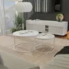 A modern living room scene featuring a white high-gloss coffee table set. Voir les images du produit