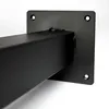 A close-up shot of a black metal table leg with a mounting plate. Náhľad obrázku produktu