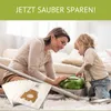 A mother and child are on the floor with a vacuum cleaner and vacuum bags. Produktbild-Vorschau