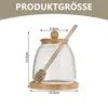 A glass honey jar with a wooden lid and dipper, shown with dimensions indicated. Produktbild-Vorschau