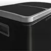 Close-up of the top corner of a black trash can with a silver trim. Produktbild-Vorschau