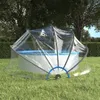 A clear pool cover is set up over a round above-ground pool in a grassy backyard with trees in the background. Podgląd zdjęcia produktu