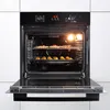 An open oven with two racks of food being cooked. Náhled obrázku produktu
