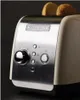 A close-up shot of a KitchenAid toaster with two slices of toast in it. Produktbild-Vorschau