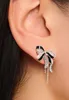 A close-up shot of a woman's ear wearing a bow-shaped earring. Produktbild-Vorschau