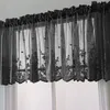 A black lace valance curtain with floral embroidery is hung across a window. Produktbild-Vorschau