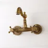 A vintage-style brass wall-mounted faucet against a white background. Podgląd zdjęcia produktu