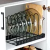 A kitchen organizer holding pot lids and a cutting board inside a cabinet. Anteprima dell’immagine prodotto