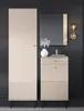 A tall, narrow cabinet and a shorter cabinet with drawers and a door are shown against a dark gray wall. A mirror hangs above the shorter cabinet, reflecting the wall and a light fixture. A vase with flowers sits on top of the shorter cabinet. Náhľad obrázku produktu
