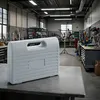 A gray toolbox sits on a metal workbench in a workshop. Produktbild-Vorschau