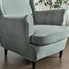 A close-up view of a light gray armchair with a velvet cover. Podgląd zdjęcia produktu