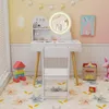 A child's vanity set with a mirror, chair, and accessories in a brightly decorated room. Podgląd zdjęcia produktu