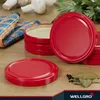 A collection of red jar lids and some bay leaves and peppercorns on a wooden surface. Produktbild-Vorschau