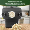 A black pasta maker accessory with dried pasta pieces on a wooden table. Podgląd zdjęcia produktu