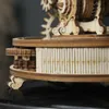 A close-up view of a wooden mechanical model, showing intricate gears and decorative elements. Náhľad obrázku produktu