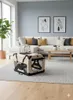 A dog crate is placed on a rug in a living room setting with a sofa and coffee table. Produktbild-Vorschau