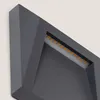 A close-up view of a modern, angular outdoor LED light fixture. Produktbild-Vorschau